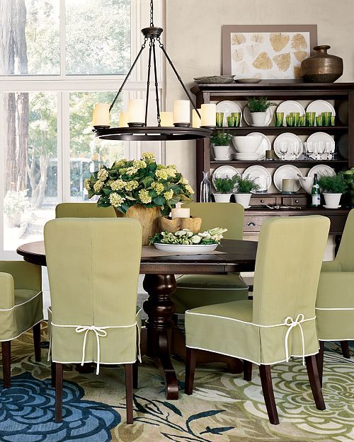 Lovely dining room. Love the green slip covers. Great rug and .