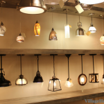 Creative pendant lighting display wall in Village Home Stores .