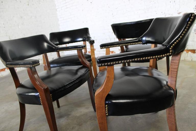 Vintage Walnut and Black Faux Leather Captain Chairs with Nailhead .