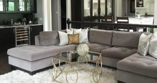 Gray sectional, black built ins and white shag rug | Rugs in .