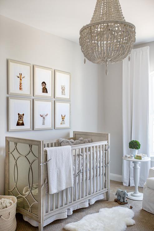 Weathered White Beaded Nrrsery Chandelier Over Gray Wood Crib .